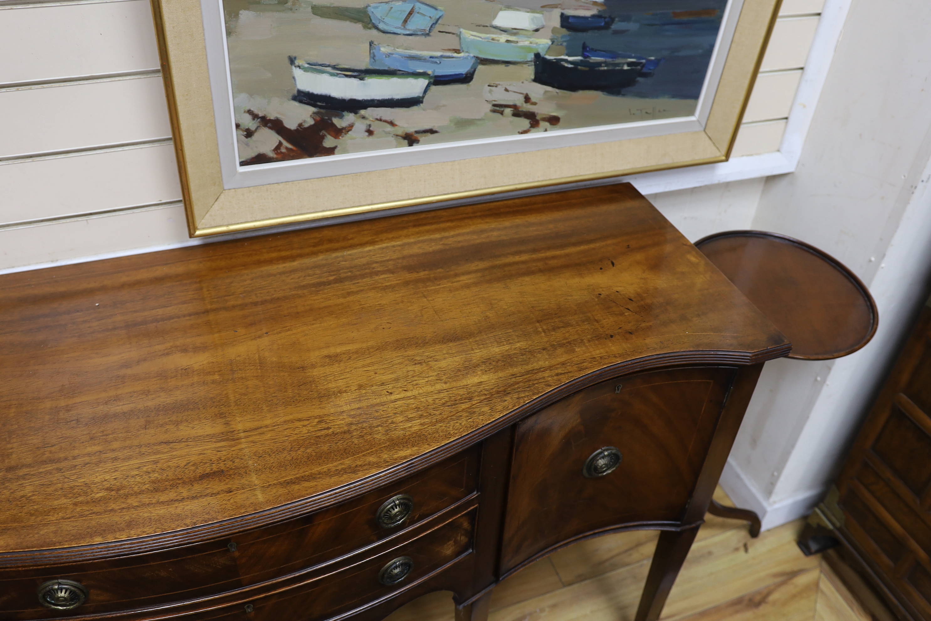 A George III style mahogany serpentine sideboard, length 152cm, depth 52cm, height 89cm